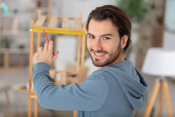 Szczęśliwy Człowiek Przywracając Drewniane Półki Balkonie — Zdjęcie stockowe