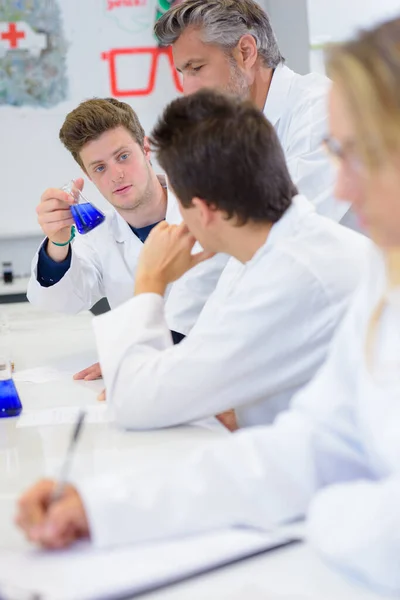 Student Showing Glass Flask Classmate — Stock Photo, Image
