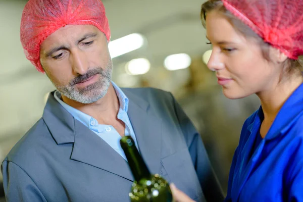 Man Woman Hairnets Looking Bottle — Stock Photo, Image