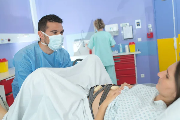 woman giving birth in labor room of hospital