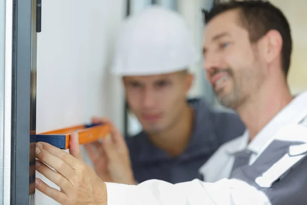 Happy Worker Inspecting Using Builders Level — Stock Photo, Image