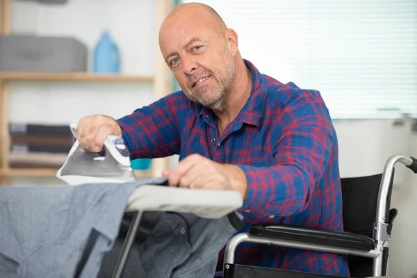 Glad Handikappad Man Rullstol Strykning Kläder — Stockfoto