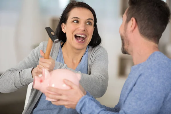 Jovem Casal Quebrando Porquinho Banco Com Martelo Casa — Fotografia de Stock