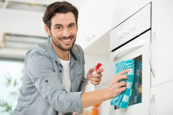 Happy Young Man Cleaning Oven Rag Bottle Spray — Stock Photo, Image