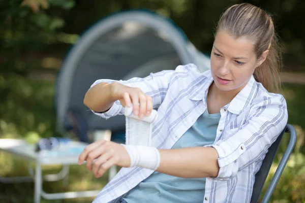 Young Woman Applying Arm Bandage Her Arm — Stock Photo, Image