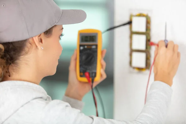 Rear View Female Electrician Using Multimeter — ストック写真