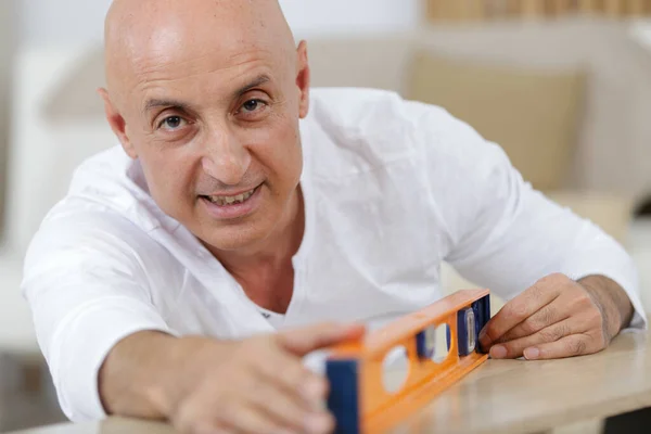 Middle Age Man Measuring Wood Piece Furniture Assembling — Stock Photo, Image