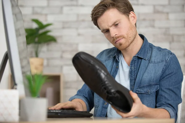 adult man working in a shoe factory close up view