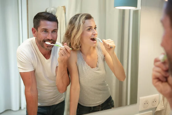 Happy Couple Bonding While Brushing Teeth Bathroom — стоковое фото