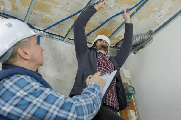 Builders Putting Repairing Suspended Ceiling — Zdjęcie stockowe