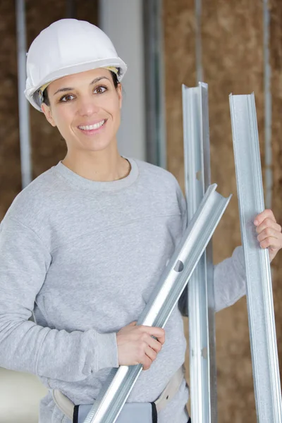 Happy Female Factory Worker Holds Metal Bars — Stok fotoğraf