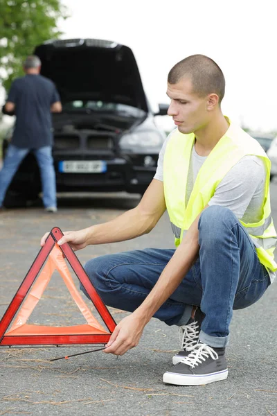 Man Placing Warning Triangle Road — Fotografia de Stock