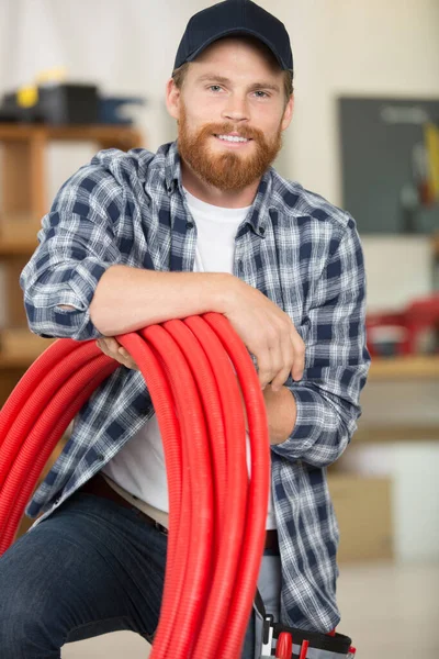 Man Holding Red Electrical Sheaths — Stockfoto