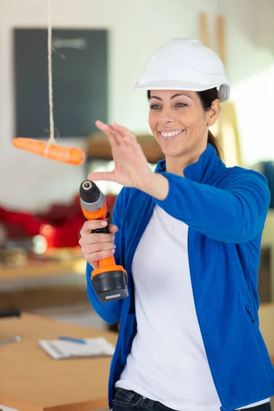 Female Worker Reaching Carrot — ストック写真