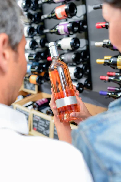 Couple Choosing Wine Bottle —  Fotos de Stock