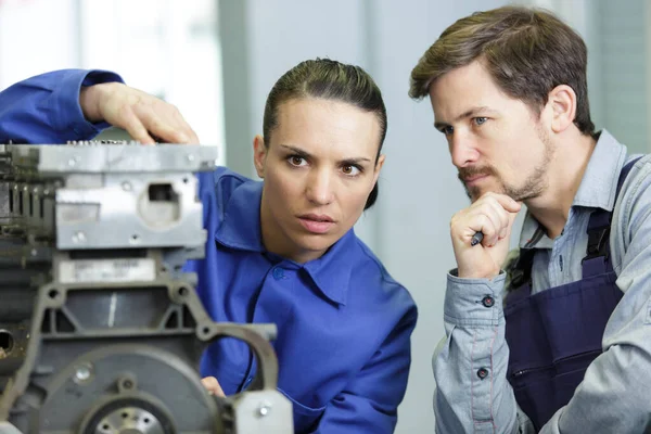 Male Female Engineering Colleagues Examining Motor — ストック写真