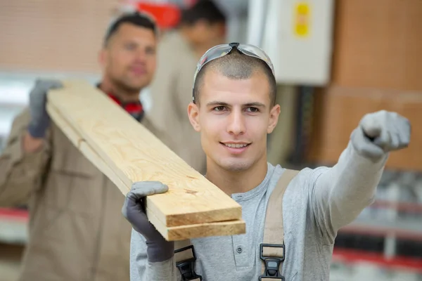 Two Men Carrying Planks Wood Together Shoulders — Stok fotoğraf