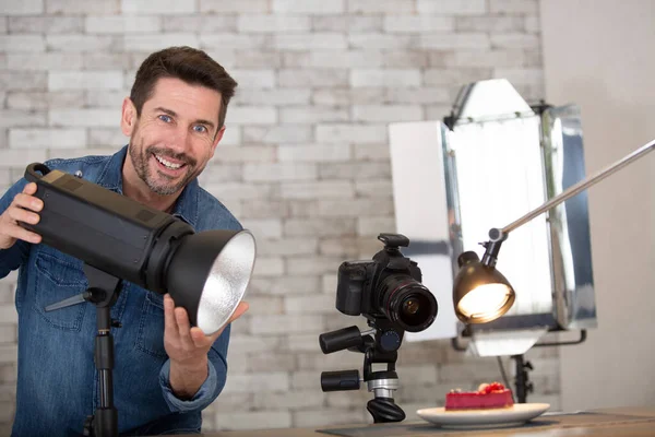 Cheerful Photographer Setting Light Photo Studio — Stockfoto