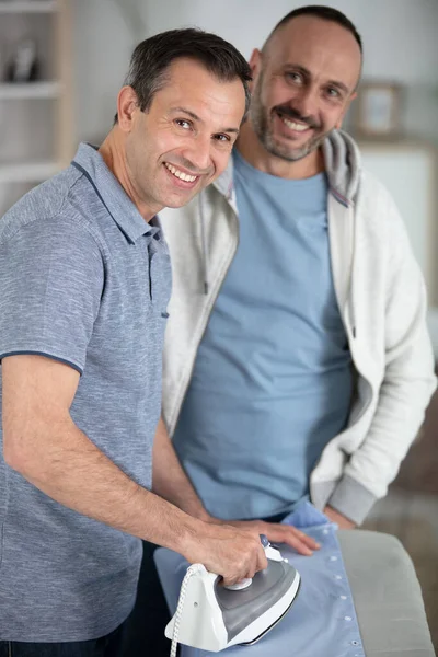 Two Men Stood Ironing Board — Stockfoto