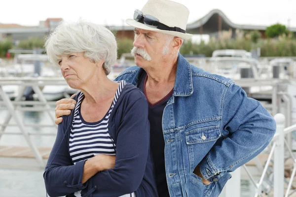 Senior Man Trying Console Grumpy Wife — стоковое фото