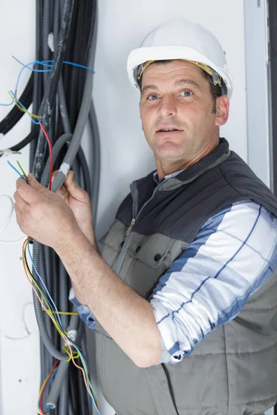 建設現場での配線を継手の電気技師 — ストック写真