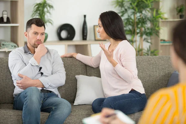 psychologist is talking to couple during therapy session