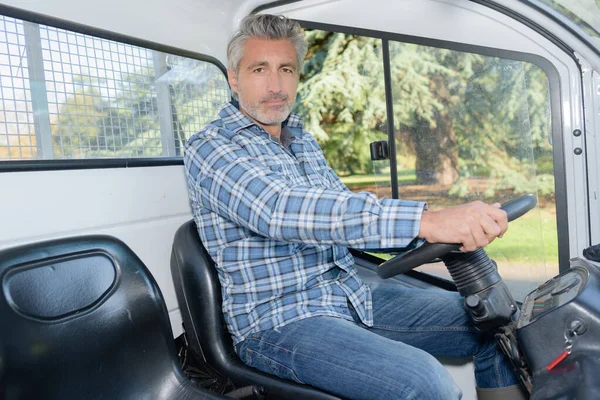 close up of man driving a lorry