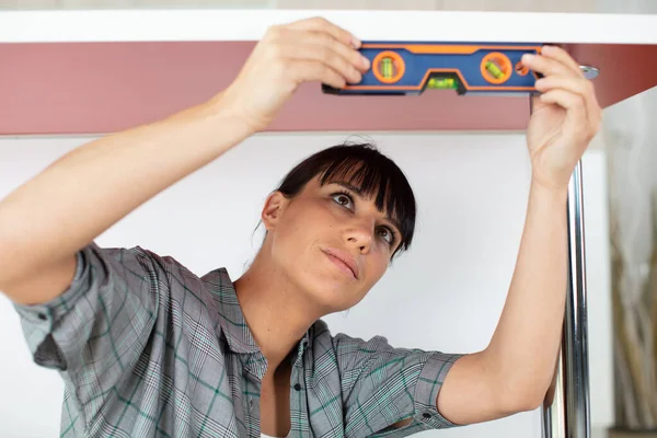 Handywoman Holding Level Ruler Stock Photo by ©photography33 575820748