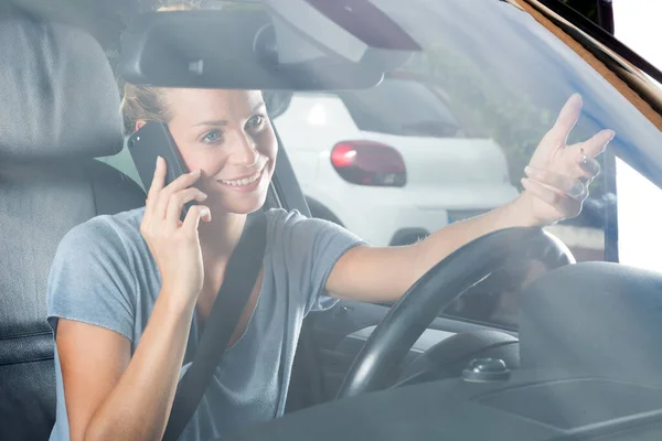 happy woman with phone in car