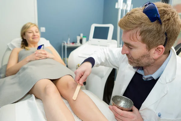 woman having a wax hair removal treatment