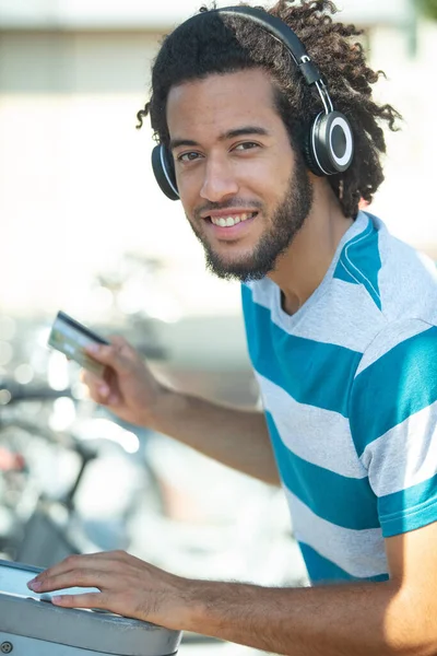 young man renting bicycle at bike