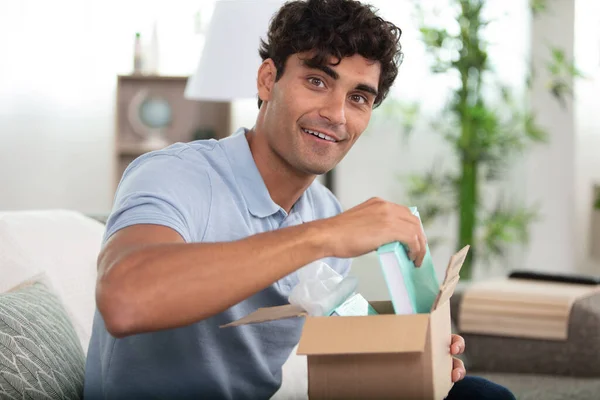 Cheerful Man Unpacking Delivery Books — Stock Photo, Image