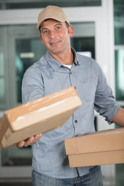 Deliveryman Uniform Holds Parcels — Stock Photo, Image