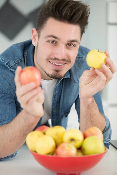 Happy Young Man Takes Apples — Stockfoto