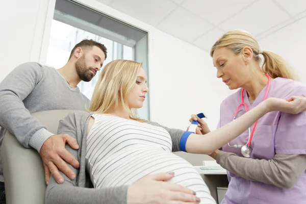 妇科医生在孕妇身上勒紧止血带采集血液样本 — 图库照片