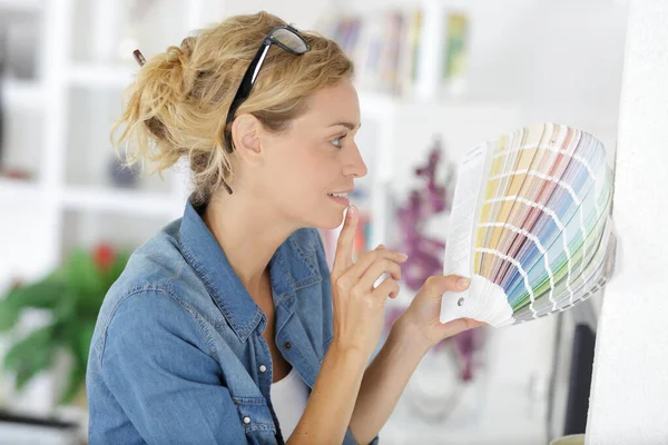 Woman Choosing Color Wall Swatches — 스톡 사진