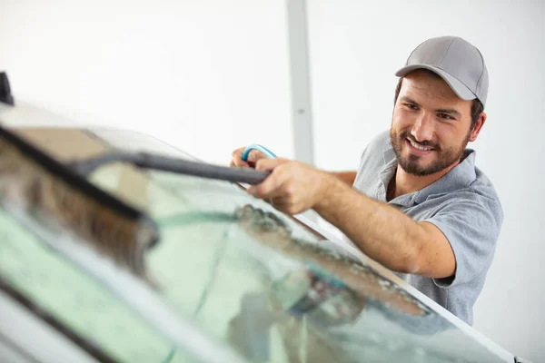 Sorridente Jovem Limpando Janela Carro — Fotografia de Stock