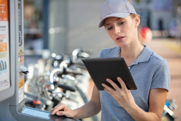 pretty female student doing practical work at factory