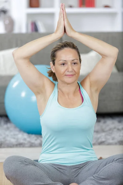 Woman Exercising Sitting Yoga Lotus Position Home — Foto de Stock