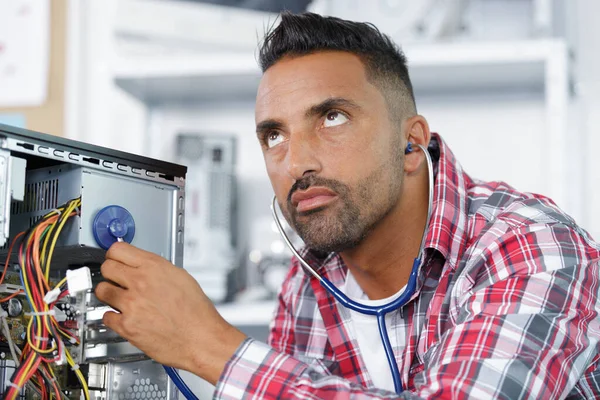 Serious Man Examines His Computer Stethoscope — Foto de Stock