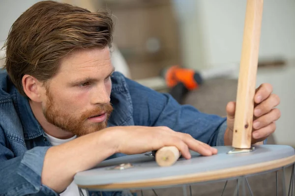 Man Repairs Broken Chair Home — Stok fotoğraf