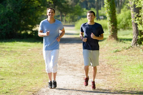 two men running in countryside together
