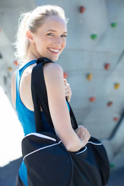 Smiling Sportswoman Holding Sports Bag — Stockfoto