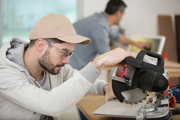 Positive Young Carpentry Student Using Circular Saw — Stockfoto