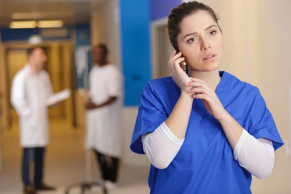 Concerned Female Doctor Uniform Talking Phone — Foto Stock