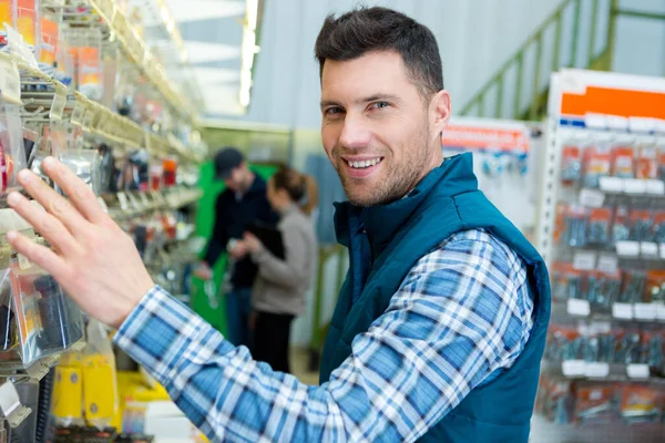 happy worker in a tool store