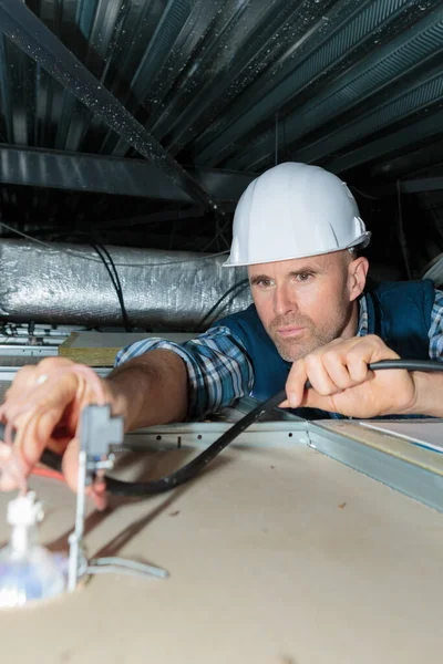 Mature Builder Installing Ceiling — Stock Fotó