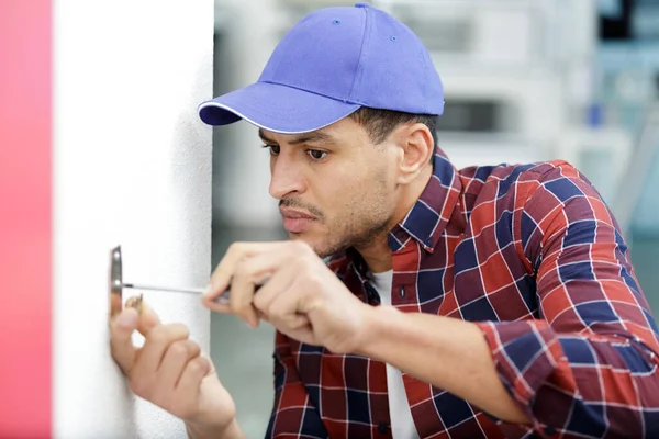 Man Fixes Electrical Switch Wall — Stock Photo, Image