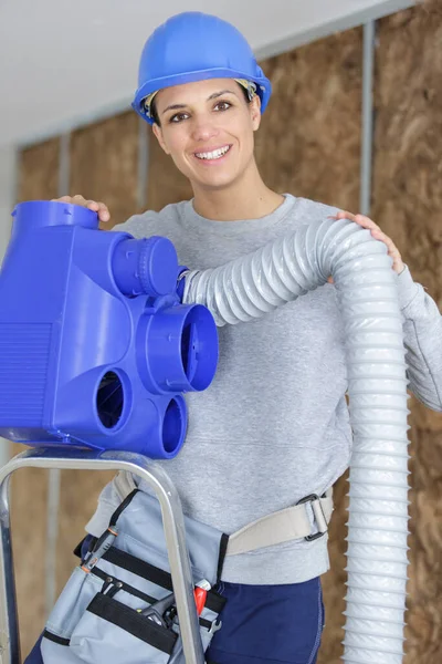 Happy Female Worker Holding Ventilation Pipes — Fotografia de Stock