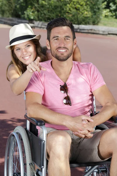 Couple Wheelchair Pointing Something Park — ストック写真